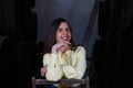 Young beautiful businesswoman sitting on a chair in her wine cellar. The woman is making different expressions and gestures Royalty Free Stock Photo