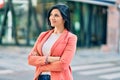 Young beautiful businesswoman smiling happy standing at the city