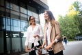 Young beautiful businesswoman talking outdoor. Office building on background. Royalty Free Stock Photo