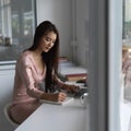 Young beautiful businesswoman typing on laptop computer and writing her idea Royalty Free Stock Photo