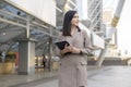 Young beautiful businesswoman is using tablet in Modern city , business technology , city lifestyle concept Royalty Free Stock Photo