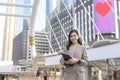 Young beautiful businesswoman is using tablet in Modern city , business technology , city lifestyle concept Royalty Free Stock Photo