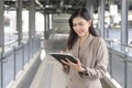 Young beautiful businesswoman is using tablet in Modern city , business technology , city lifestyle concept Royalty Free Stock Photo