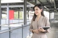 Young beautiful businesswoman is using tablet in Modern city , business technology , city lifestyle concept Royalty Free Stock Photo