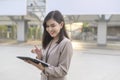 Young beautiful businesswoman is using tablet in Modern city , business technology , city lifestyle concept Royalty Free Stock Photo