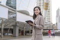 Young beautiful businesswoman is using tablet in Modern city , business technology , city lifestyle concept Royalty Free Stock Photo