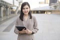 Young beautiful businesswoman is using tablet in Modern city , business technology , city lifestyle concept Royalty Free Stock Photo