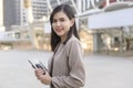 Young beautiful businesswoman is using tablet in Modern city , business technology , city lifestyle concept Royalty Free Stock Photo