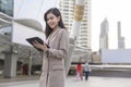 Young beautiful businesswoman is using tablet in Modern city , business technology , city lifestyle concept Royalty Free Stock Photo