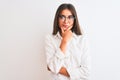 Young beautiful businesswoman wearing glasses standing over isolated white background looking confident at the camera smiling with Royalty Free Stock Photo