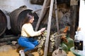 Young and beautiful businesswoman working in her winery taking a bunch of grapes from a basket in which they are being weighed