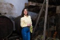 Young and beautiful businesswoman working in her winery taking a bunch of grapes from a basket in which they are being weighed