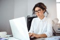 Young beautiful businesswoman working with laptop at workplace in office. Royalty Free Stock Photo