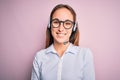 Young beautiful call center agent woman wearing glasses working using headset with a happy and cool smile on face Royalty Free Stock Photo