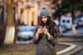 Young beautiful casual girl calling on her cell phone on spring city street Royalty Free Stock Photo