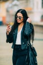 Young beautiful casual girl takes a selfie on her cell phone with sunglasses Royalty Free Stock Photo