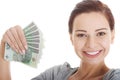 Young beautiful casual woman holding large sum of money. Royalty Free Stock Photo