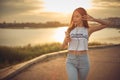 Young beautiful caucasian blonde girl listening to music with smartphone walking in the city with headphones smiling - relax, Royalty Free Stock Photo