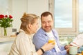 Young beautiful happy couple having breakfast together in kitchen at home. Lifestyle Royalty Free Stock Photo