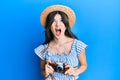 Young beautiful caucasian girl holding vintage camera angry and mad screaming frustrated and furious, shouting with anger looking Royalty Free Stock Photo