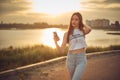 Young beautiful caucasian girl listening to music with smartphone walking in the city with headphones smiling - relax, youth, Royalty Free Stock Photo