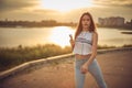 Young beautiful caucasian girl listening to music with smartphone walking in the city with headphones smiling - relax, youth, Royalty Free Stock Photo