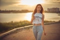 Young beautiful caucasian girl listening to music with smartphone walking in the city with headphones smiling - relax, youth, Royalty Free Stock Photo