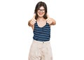 Young beautiful caucasian girl wearing casual clothes and glasses approving doing positive gesture with hand, thumbs up smiling Royalty Free Stock Photo