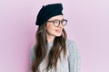 Young beautiful caucasian girl wearing french look with beret looking to side, relax profile pose with natural face and confident Royalty Free Stock Photo