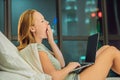 Young beautiful, caucasian, red haired, internet addicted woman working bored, sleepless and tired on her laptop in bed Royalty Free Stock Photo