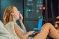 Young beautiful, caucasian, red haired, internet addicted woman working bored, sleepless and tired on her laptop in bed Royalty Free Stock Photo