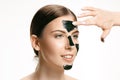 Young beautiful woman applying a mask for the face of the therapeutic black mud. Spa treatment Royalty Free Stock Photo