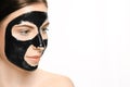 Young beautiful woman applying a mask for the face of the therapeutic black mud. Spa treatment Royalty Free Stock Photo