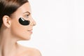 Young beautiful woman applying a mask for the face of the therapeutic black mud. Spa treatment Royalty Free Stock Photo