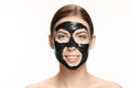 Young beautiful woman applying a mask for the face of the therapeutic black mud. Spa treatment Royalty Free Stock Photo