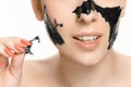 Young beautiful woman applying a mask for the face of the therapeutic black mud. Spa treatment Royalty Free Stock Photo