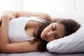 Young beautiful Caucasian woman on bed being sad, depressed, having stomach pain, having food poisoning, cramps sickness Royalty Free Stock Photo