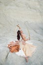 Young beautiful Caucasian brunette woman belly dancer posing in desert with swords Royalty Free Stock Photo