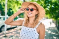 Young beautiful caucasian woman with blond hair smiling happy outdoors on a summer day wearing sunglasses Royalty Free Stock Photo