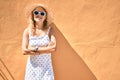 Young beautiful caucasian woman with blond hair smiling happy outdoors on a summer day wearing sunglasses Royalty Free Stock Photo