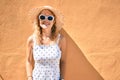 Young beautiful caucasian woman with blond hair smiling happy outdoors on a summer day wearing sunglasses Royalty Free Stock Photo