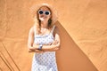 Young beautiful caucasian woman with blond hair smiling happy outdoors on a summer day wearing sunglasses Royalty Free Stock Photo