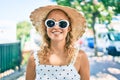 Young beautiful caucasian woman with blond hair smiling happy outdoors on a summer day wearing sunglasses Royalty Free Stock Photo