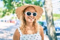 Young beautiful caucasian woman with blond hair smiling happy outdoors on a summer day wearing sunglasses Royalty Free Stock Photo