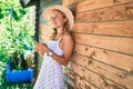 Young beautiful caucasian woman with blond hair smiling happy outdoors using smartphone Royalty Free Stock Photo