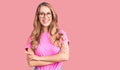 Young beautiful caucasian woman with blond hair wearing casual clothes and glasses happy face smiling with crossed arms looking at Royalty Free Stock Photo