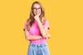 Young beautiful caucasian woman with blond hair wearing casual clothes and glasses looking confident at the camera smiling with Royalty Free Stock Photo