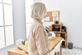 Young beautiful caucasian woman at construction office looking to side, relax profile pose with natural face with confident smile Royalty Free Stock Photo