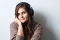 caucasian woman with curly hair in sweater with headphones