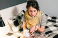 Young beautiful Caucasian woman has a cold, flu with high fever and heat at home in bed. The girl takes headache pills with a Royalty Free Stock Photo